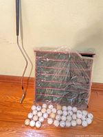 Rack, putter and bag of golf balls overview