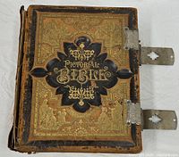 Front cover showing ornate tooling, title "Pictorial Bible", metal clasps, wear to spine