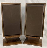 Front view of both speakers on stands with grilles attached