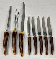 Full view of eight resin-handled cutlery pieces