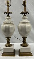 Full view of both matching porcelain and brass table lamps showing overall design and height