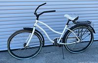 Left side full view of bicycle showing frame, wheels, handlebars, rack