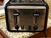 Front view of Black+Decker 4-slice toaster showing controls and logo