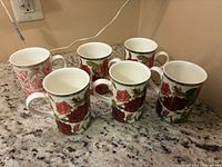 Six bone china floral mugs grouped on countertop