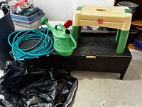 Step2 bench, green hose, green watering can, folded black cover