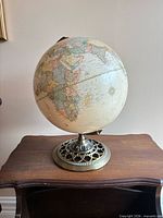 Full view of globe on tabletop showing map detail and base