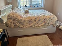 Bed made up showing white captain bed with drawers