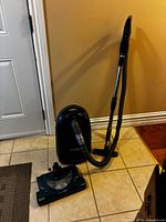 Full vacuum with canister, hose, wand and powerhead visible