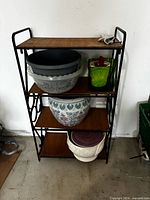 Front view of metal stand and all planters on shelves