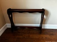 Front view of dark wood quilt rack