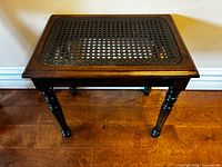 Table front angle showing cane insert and legs