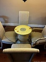 Full view of round glass-top table with four chairs