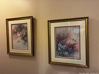 Both framed prints hanging side by side