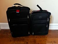 Front view of both Protocol suitcases showing size difference and exterior features