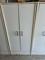 Front view of full white cabinet with doors closed