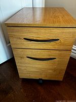 Front view of two-drawer wooden filing cabinet