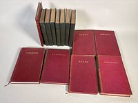 Group shot of all books: six red Poetical Works, seven Bret Harte, one additional red book