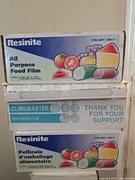 Front view of three food film boxes showing brands and graphics