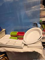 overall view of stacked white bakeware and colored ramekins