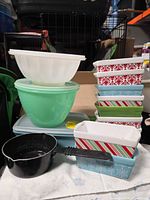 Group shot showing bowls, container, loaf pans, ramekins, saucepan