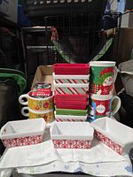 Group of loaf pans, mugs and cookie cutter set displayed together