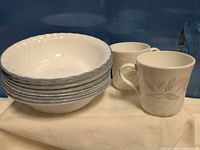 Stack of eight Corelle bowls and two Corning mugs