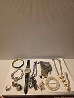 Full lot overview showing all jewellery pieces on white background