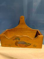 Full view of wooden wall rack with duck motif