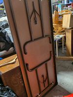 Underside showing folded metal legs and frame