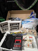 Overview of lot with cabinet pulls, Capita legs, dowels, tools and screw packs