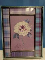 Front of frame showing plaid border and floral insert