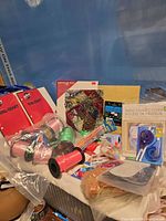 Wide view of lot showing ribbons, notebooks, paper pad, tape, envelopes, patio cover