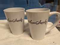 Front view of both Laura Secord mugs showing logos