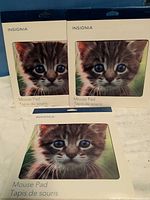 Front of three sealed Insignia mouse pads