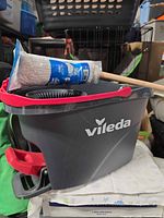 Side view of Vileda bucket showing logo, red handle, mop refill on top