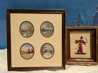 Both framed needlepoint pieces side by side