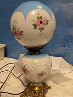 Full view of lamp showing both globes, base, and cord