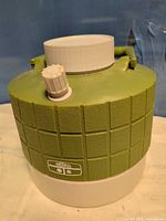 Front view of green Thermos jug showing brand badge, white base, pour spout cap and handle