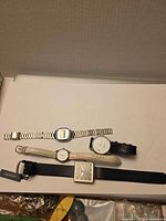 All four wristwatches laid out in a row