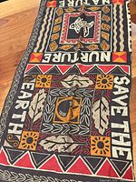 Full view of scarf showing SAVE THE EARTH and NATURE text, fish motif, overall color scheme