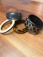 Four resin bangles arranged on wood surface