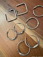 All five pairs laid out showing variety of shapes, finishes and closures