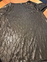 Full front view of black sequin mesh top