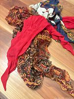 All three scarves layered together showing colors and patterns