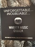 Front of black slipcase showing title and Warner Music Canada logo