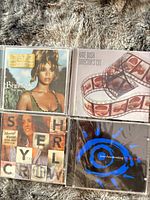 All four CD front covers in jewel cases