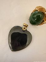 Pendant and ring close-up showing stones and gold-tone metal