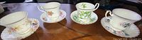 Four Royal Albert teacup and saucer sets on table