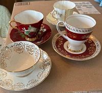 All four teacup and saucer sets displayed upright