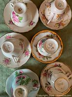 All six teacup and saucer sets pictured from above showing patterns and maker marks